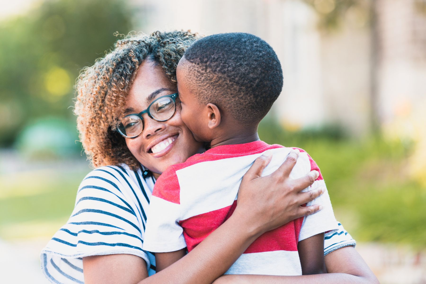 woman hugging young child