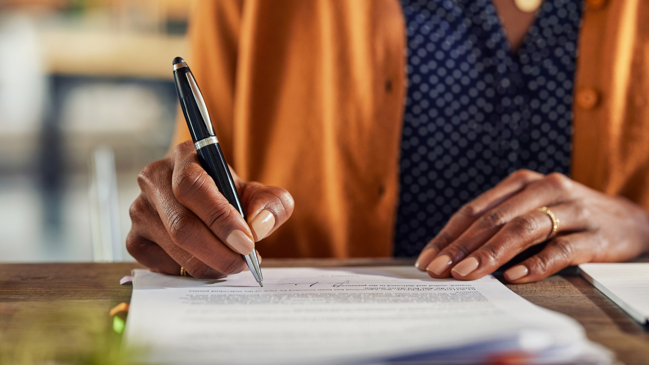 woman writing and organizing paperwork